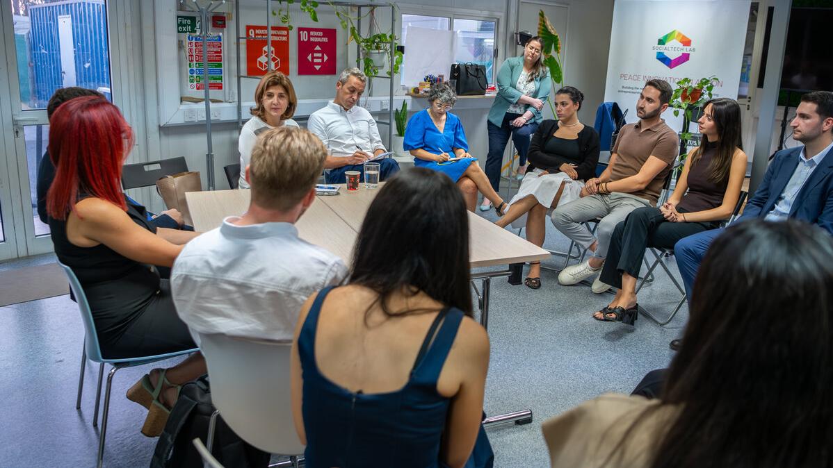 A photo of the Personal Envoy of the Secretary-General on Cyprus, María Ángela Holguín, with a group of participants at an event. 