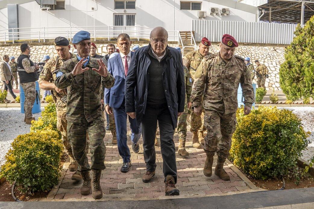 Lieutenant General Aroldo Lázaro and Prime Minister Najib Miqati walk with peacekeepers.